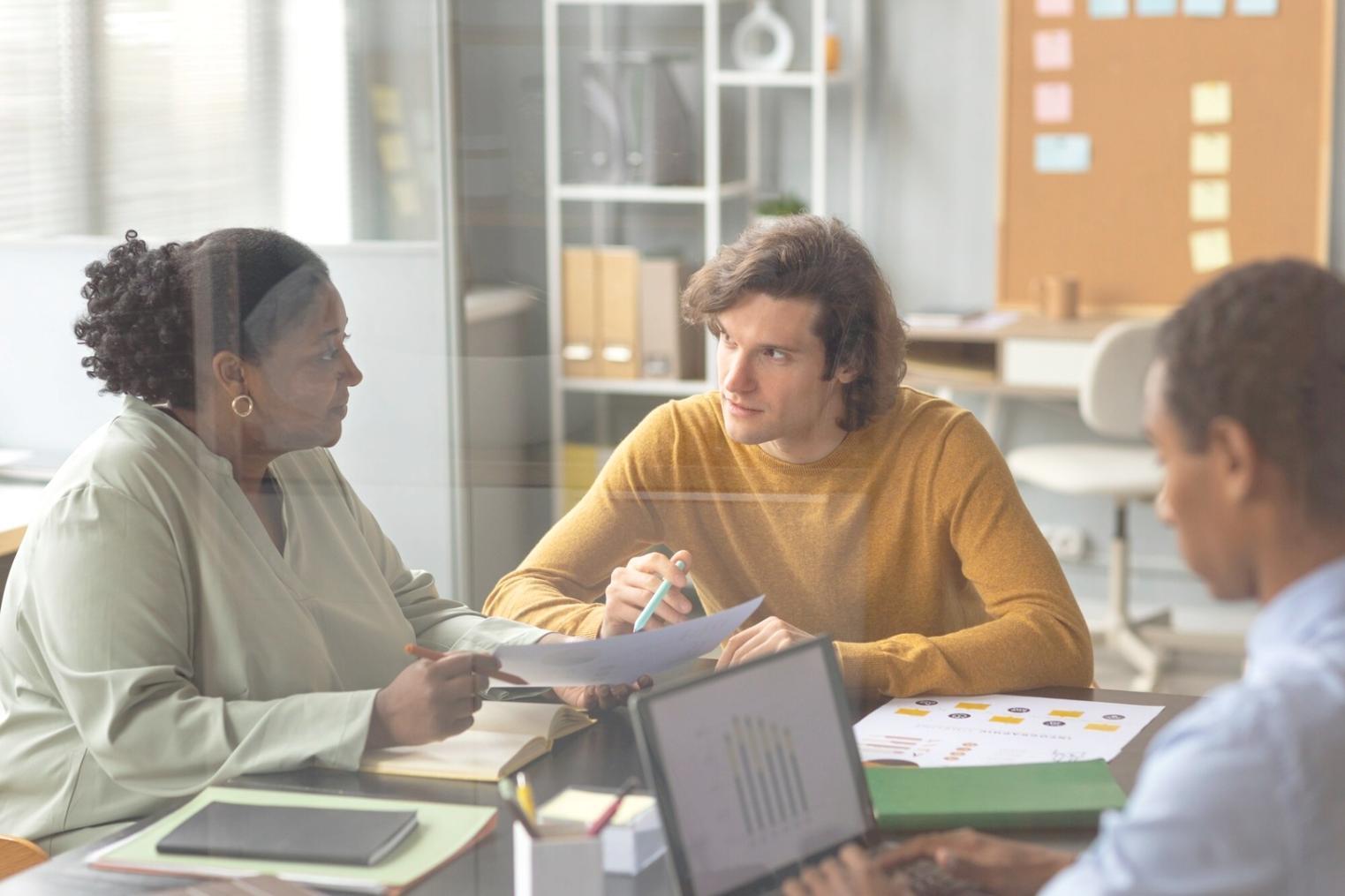 Financial planning workspace with budgeting documents and laptop